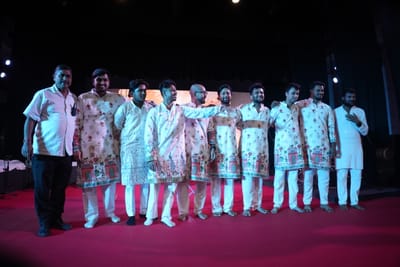 The Antara band lined up across the stage at the close, arms around each other's shoulders in matching printed kurtas.