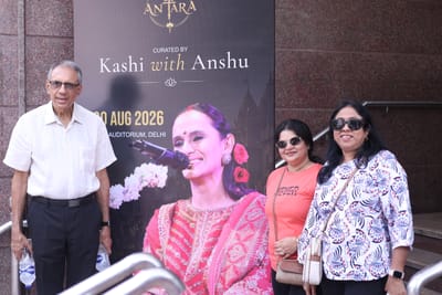Guests standing beside the Antara standee outside the auditorium before the show.